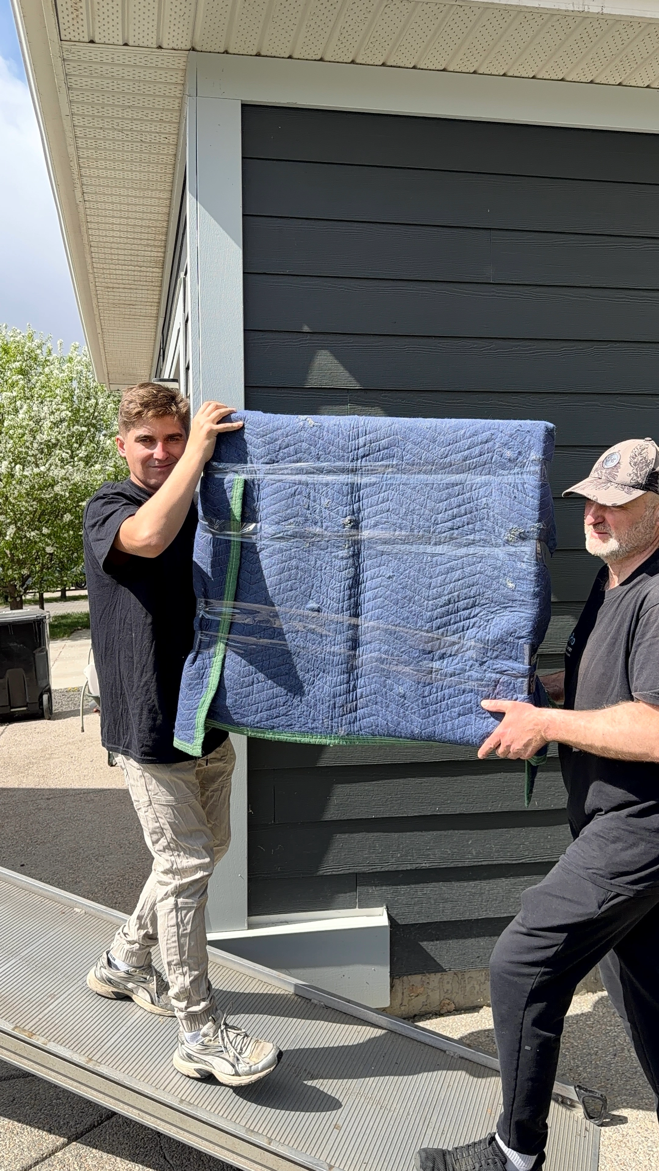 Movers carrying packed boxes during a Calgary move